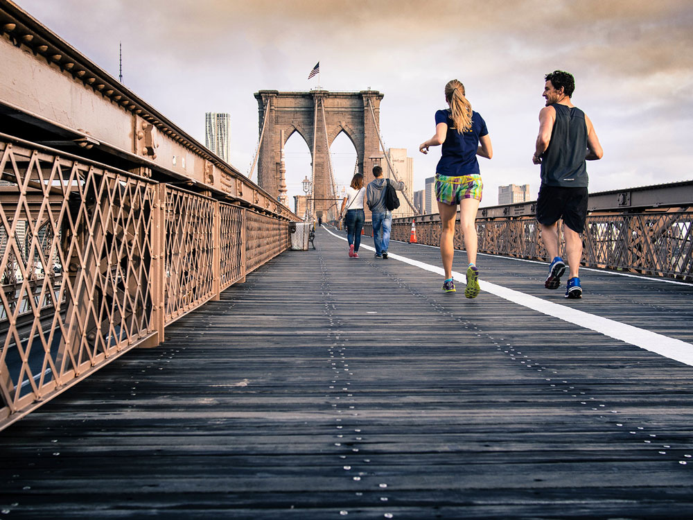 People jogging together on Manhattan's bridge