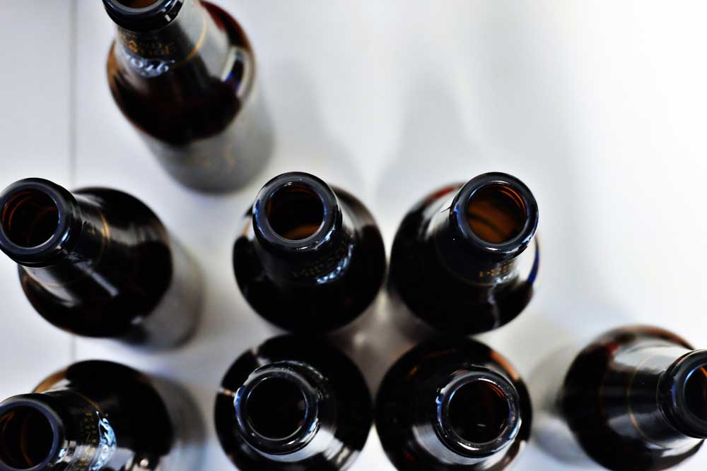 Many empty bottles of beer on a table