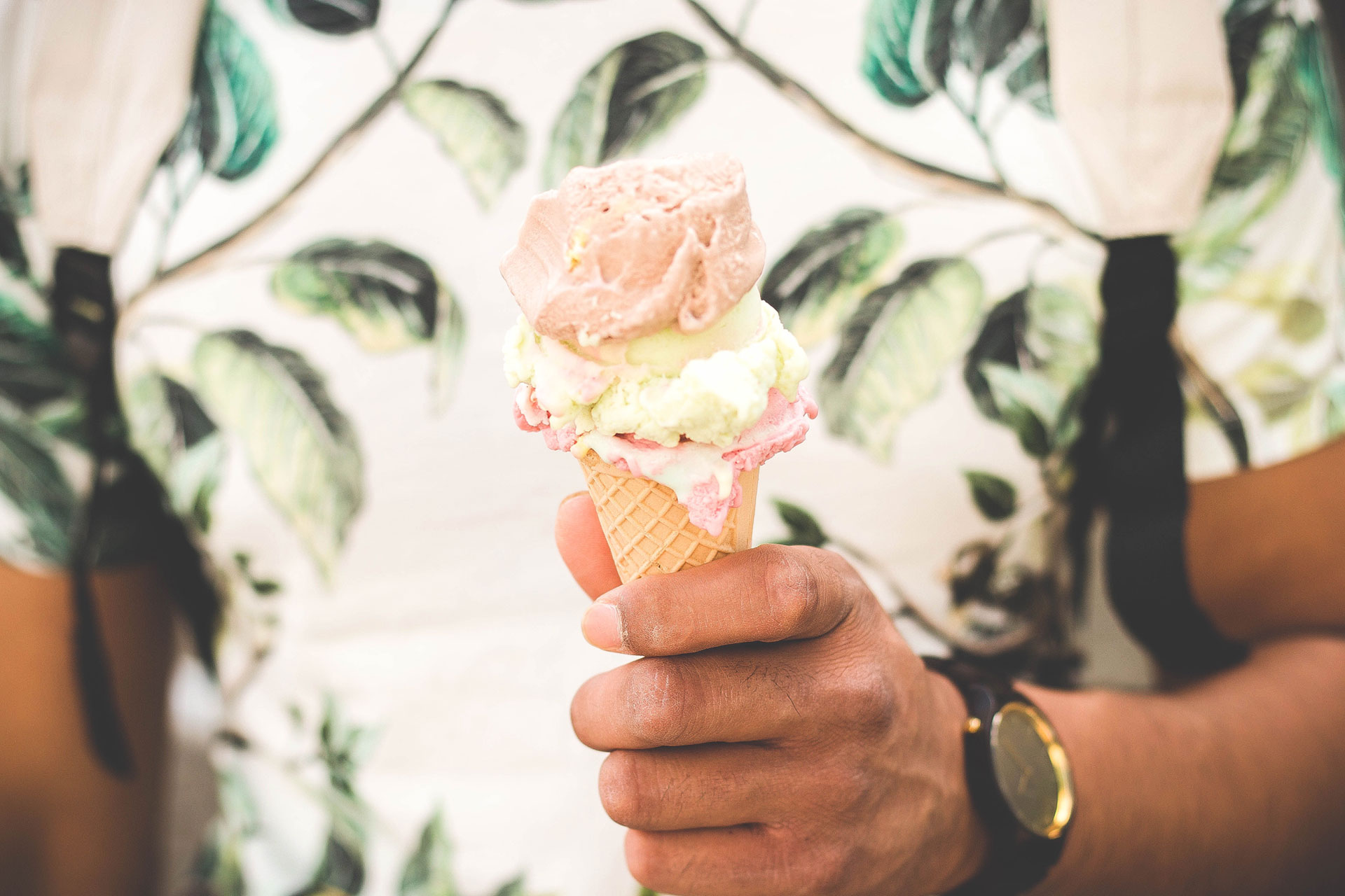 Man in a tropical shirt holding an ice cream cone