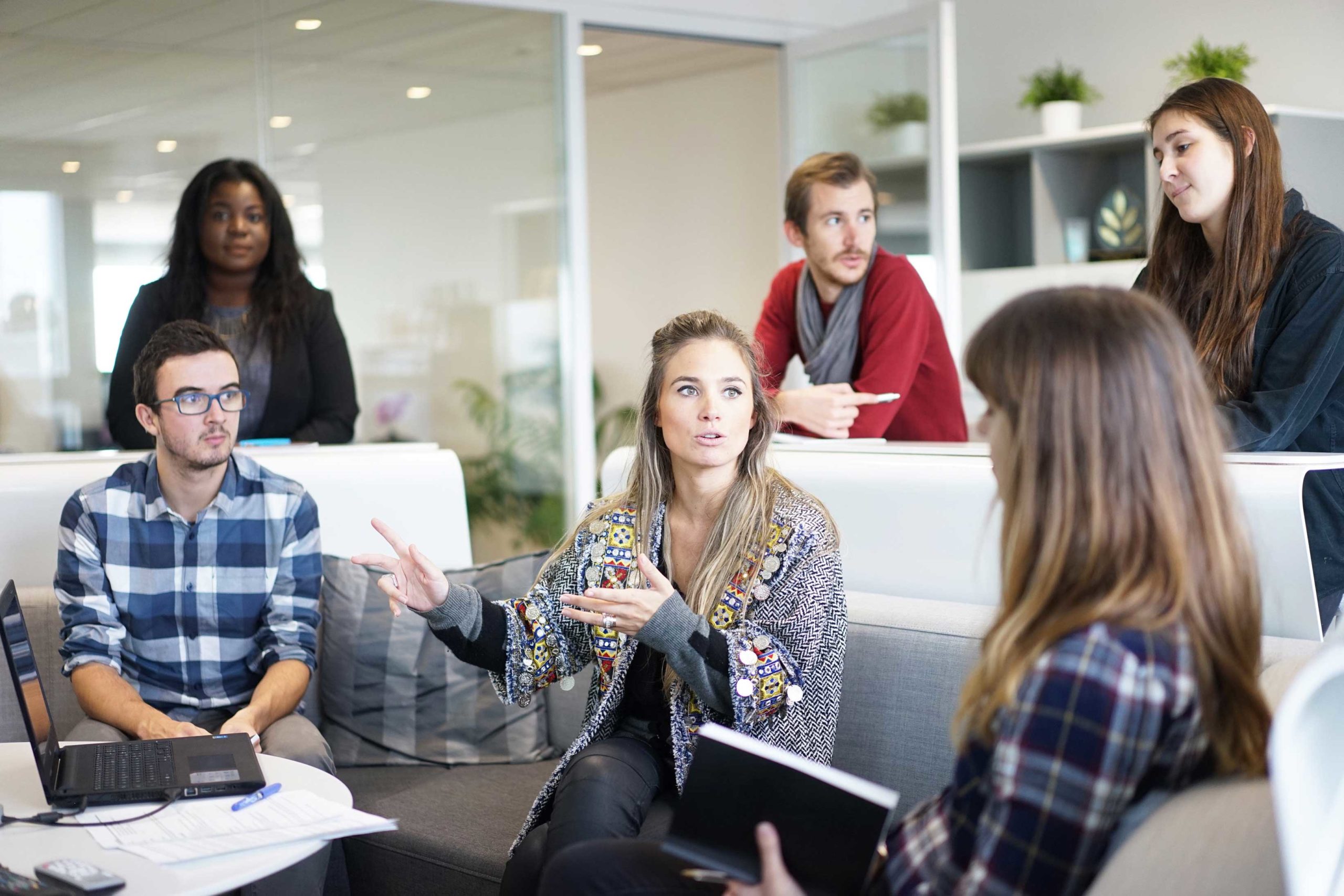 A female employee gestures as she talks in a casual meeting