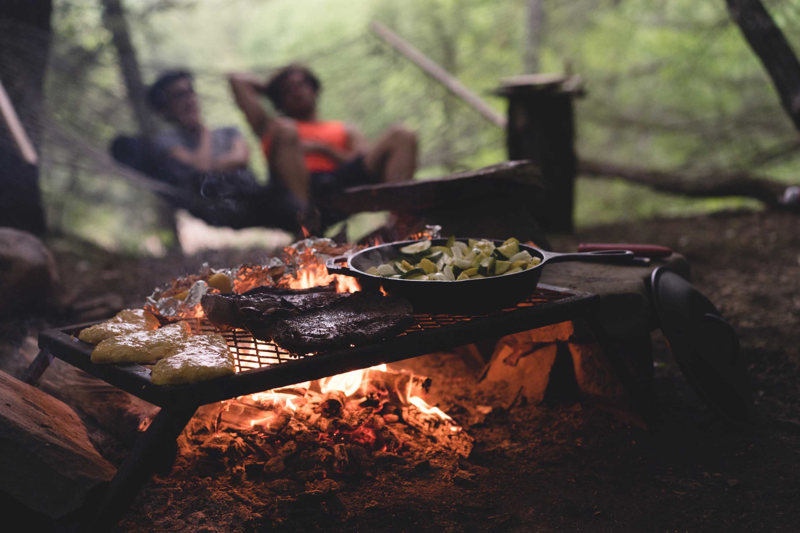 Firepit barbeque with a grill covered in food