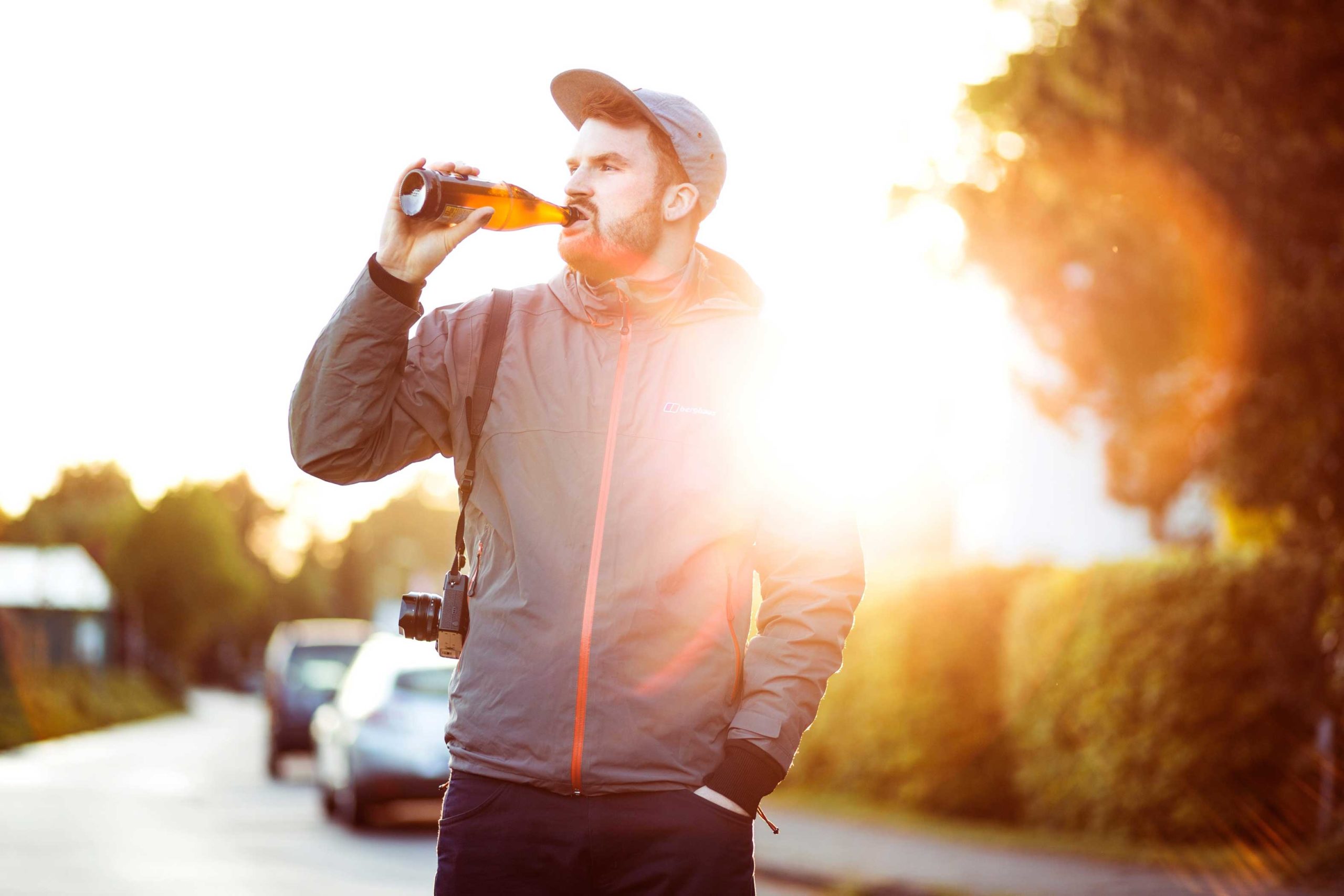 Guy drinking beer in the sunset