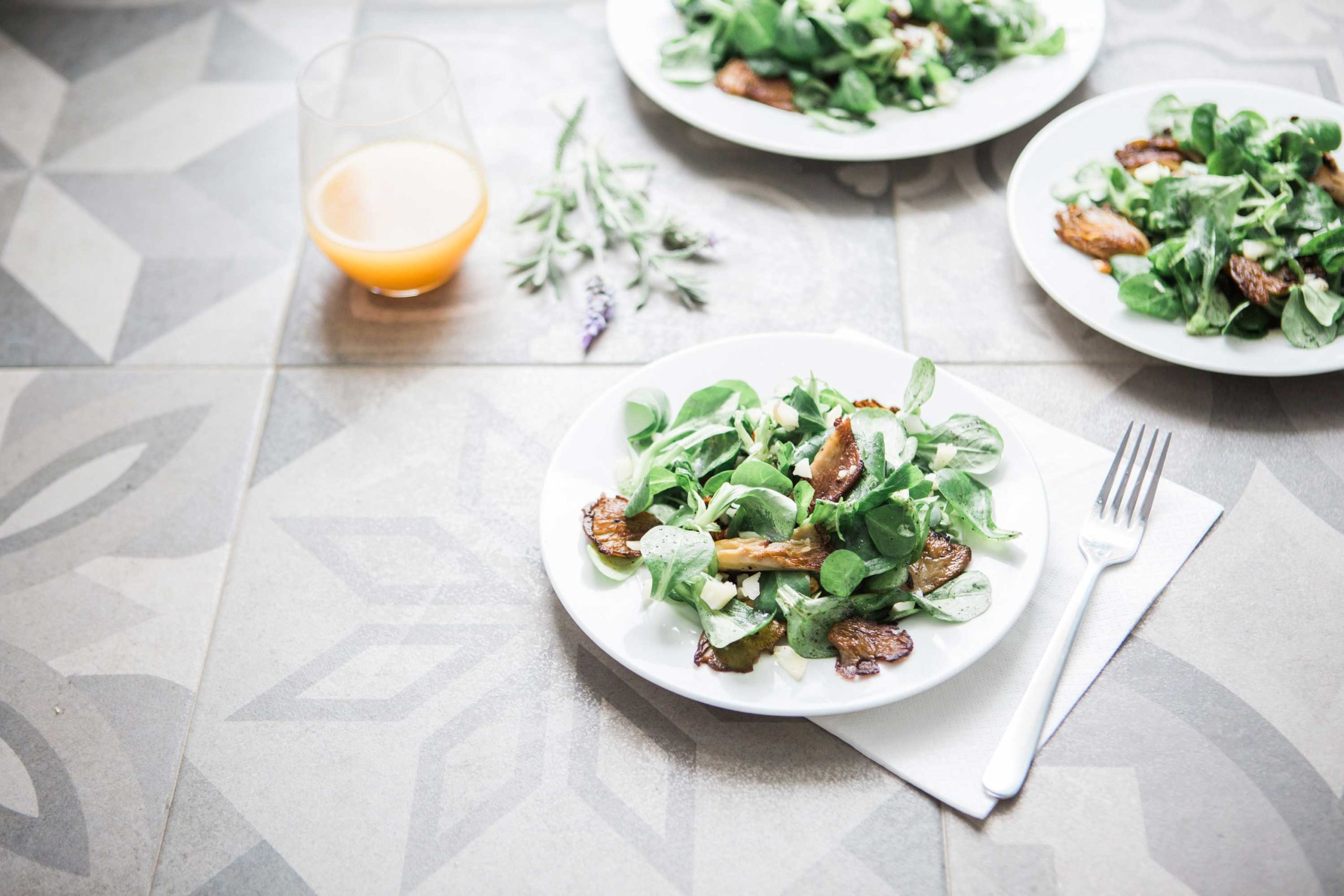 Salads and orange juice on a table