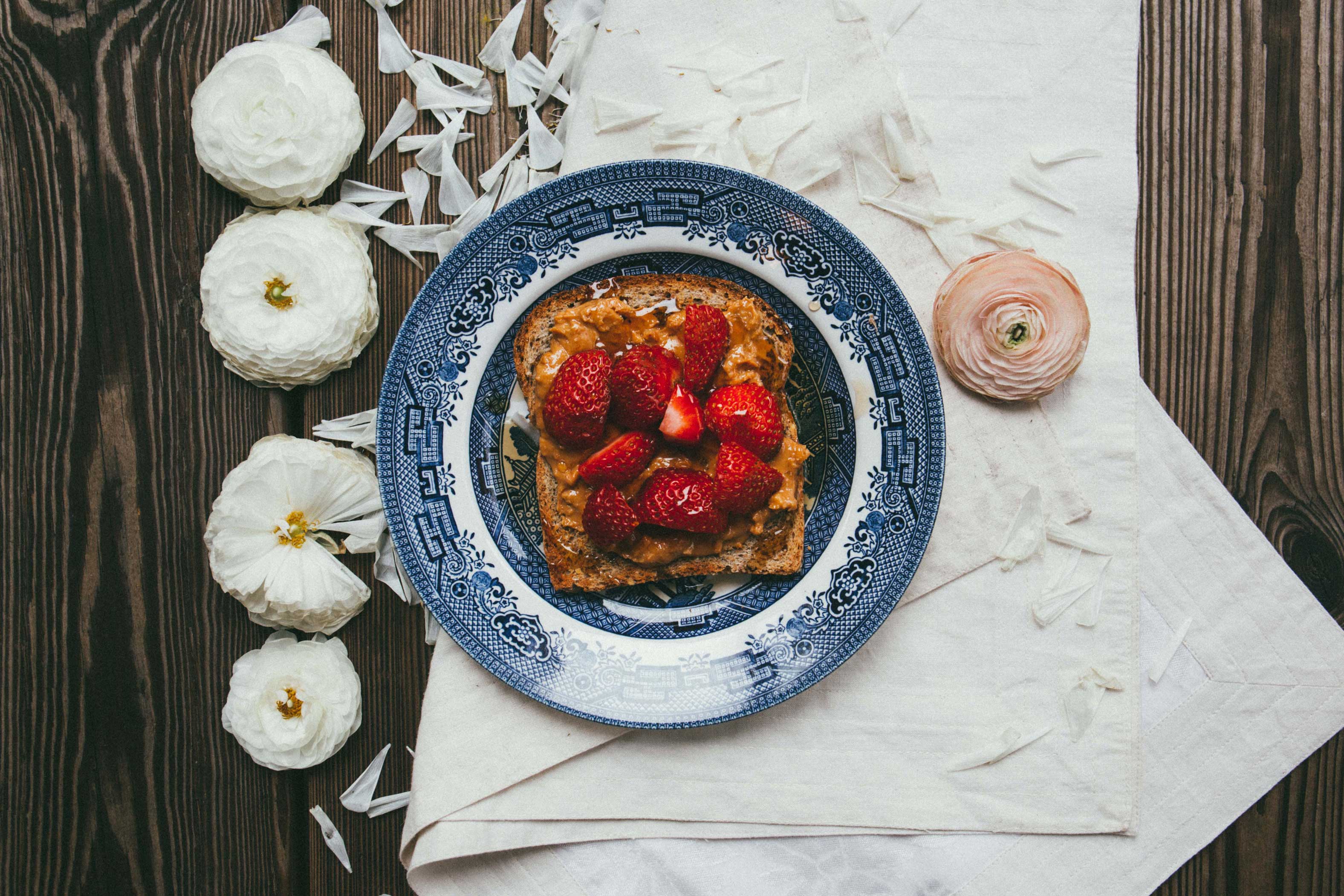 Peanut butter and fresh strawberries on toast