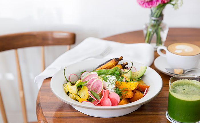 Josephine House's green juice, coffee, and healthy bowl on a table