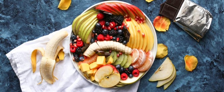Fresh fruit in a bowl on a countertop with chocolate