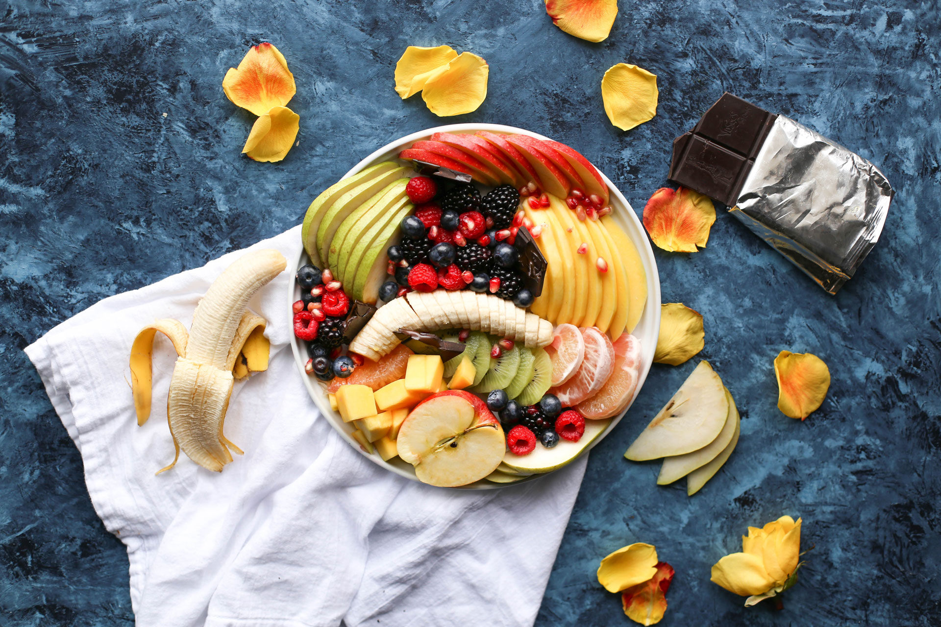 Fresh fruit in a bowl on a countertop with chocolate