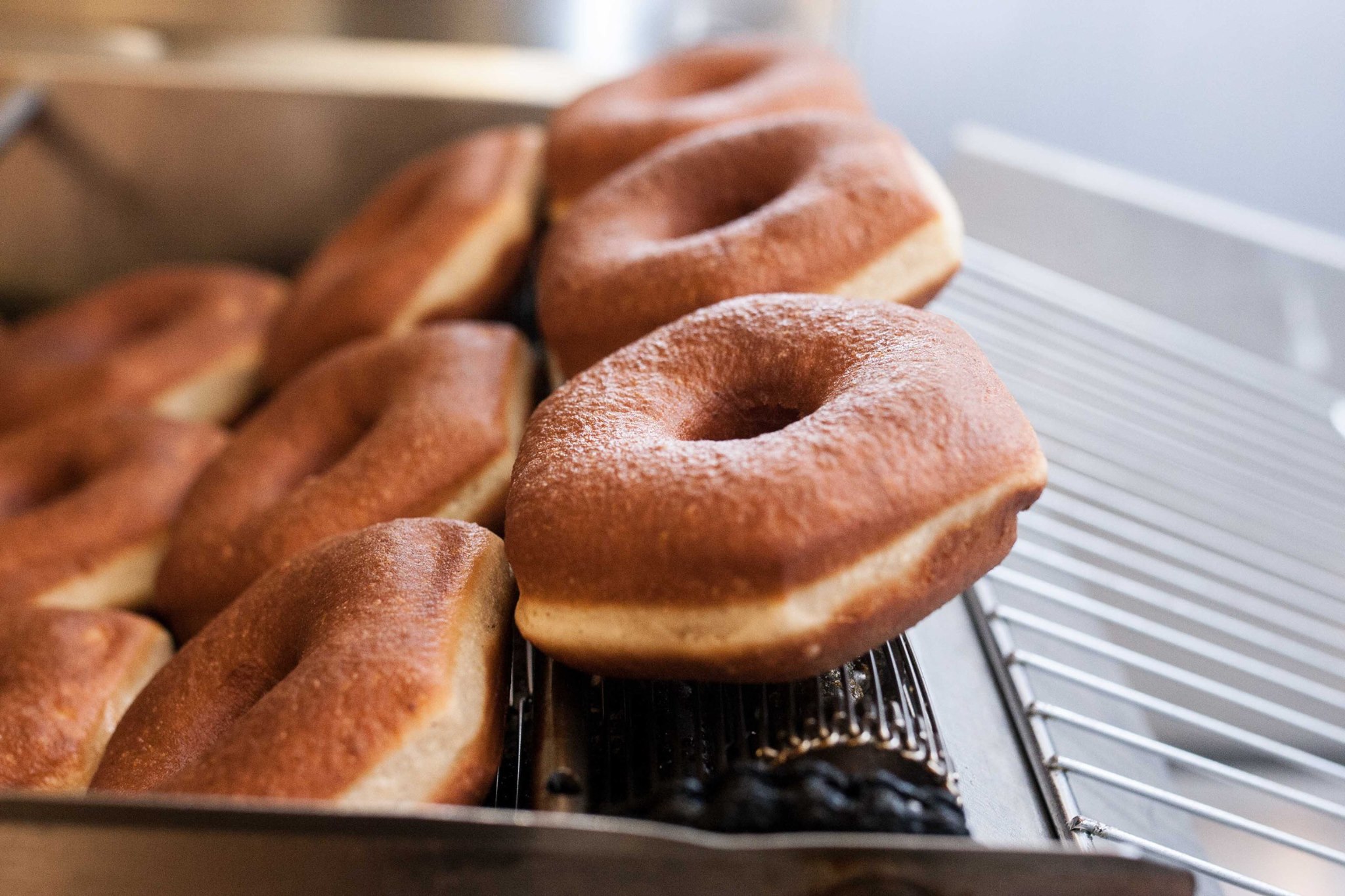 Cartems donuts coming out on a conveyer tray