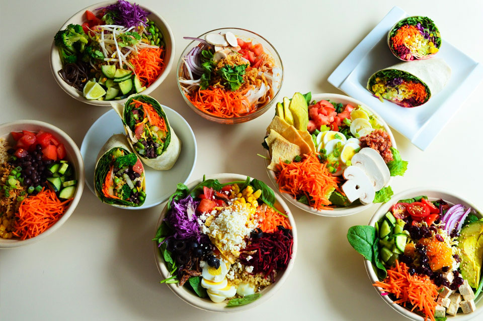 An array of veggie dishes including salad wraps and rice bowls from AAamazing Salad