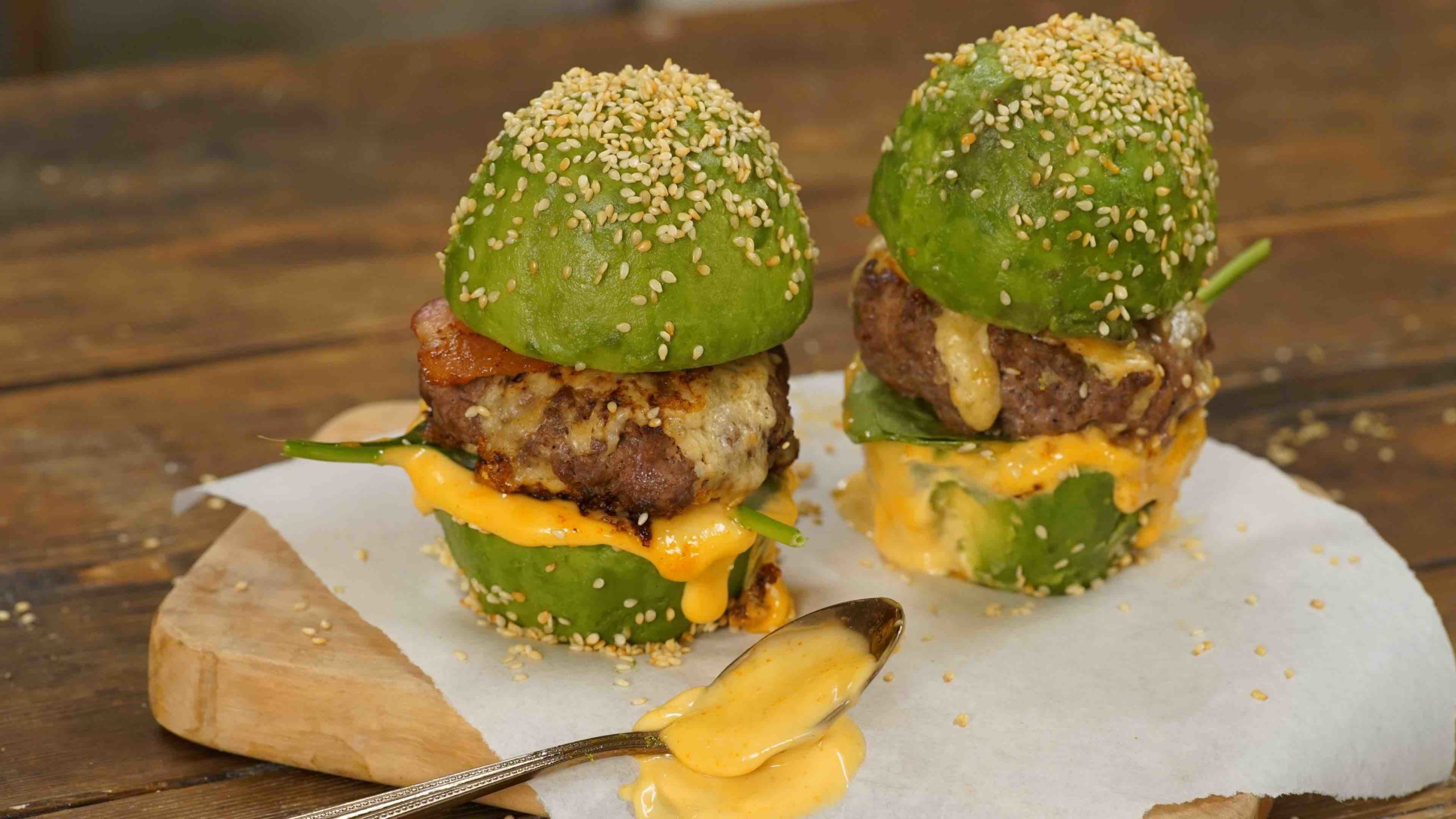 Two burgers with avocado buns instead of bread buns