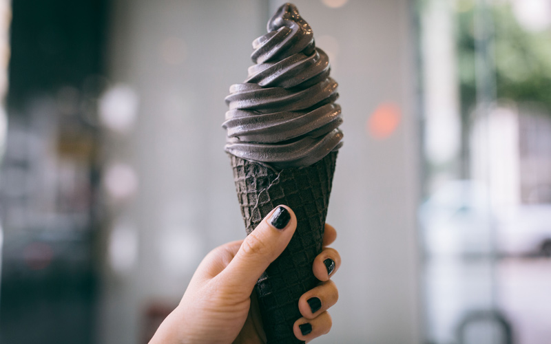 Black ice cream in a black waffle cone