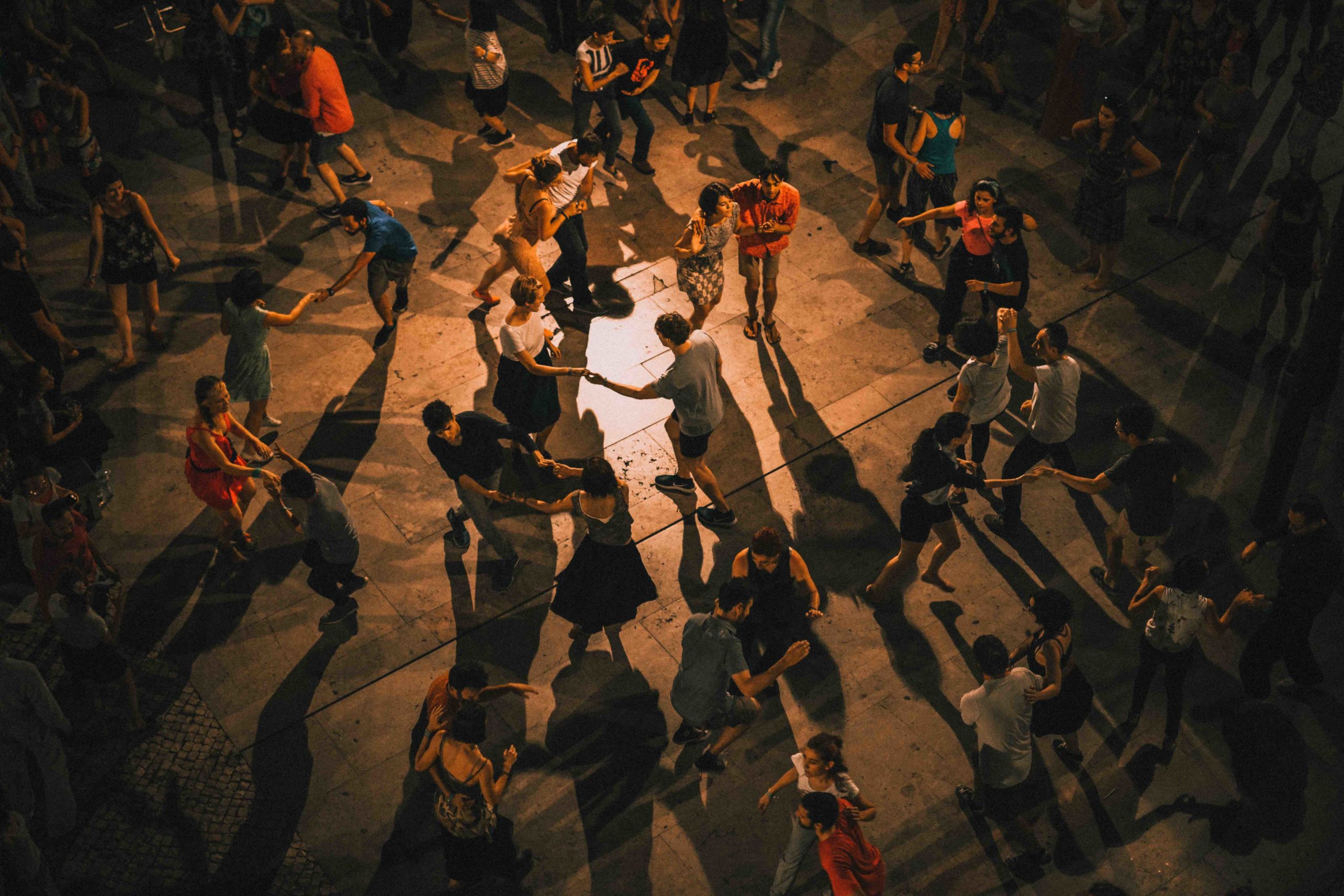 People dancing at night in a square
