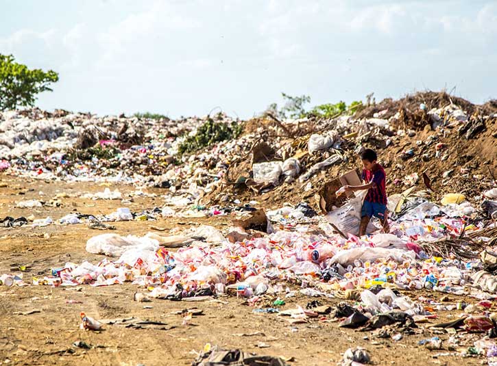 A child wades through a garbage dump 