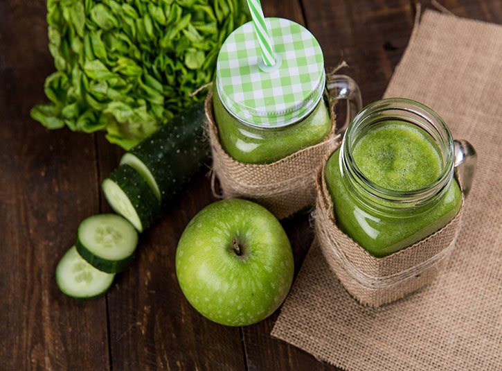 Green apple, lettuce, and cucumber smoothies in glasses