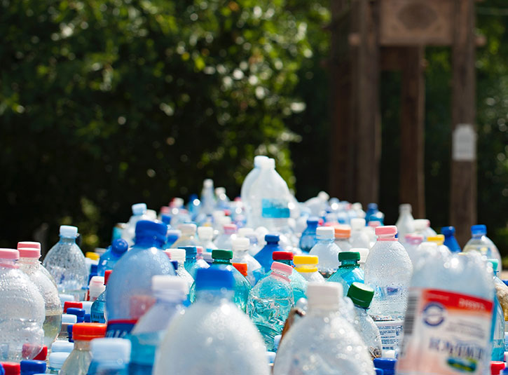 Hundreds of water bottles lined up outside for recycling