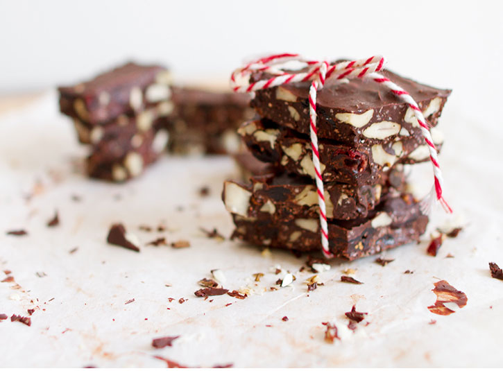 Almond chocolate brittle pieces stacked and wrapped in candy cane-colored string 