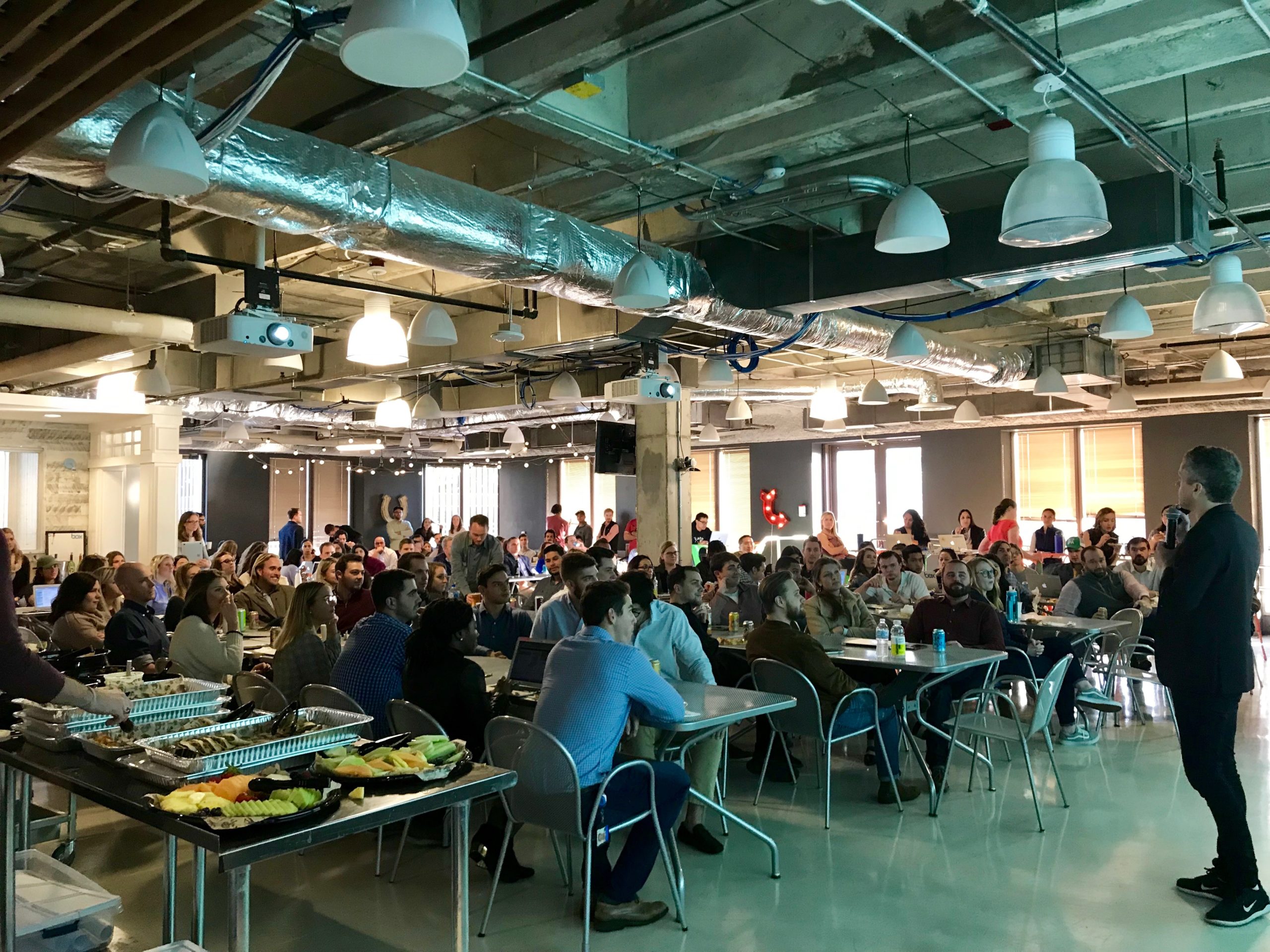 Inside of Box software company's dining hall full of employees sitting down to catered lunch and learn