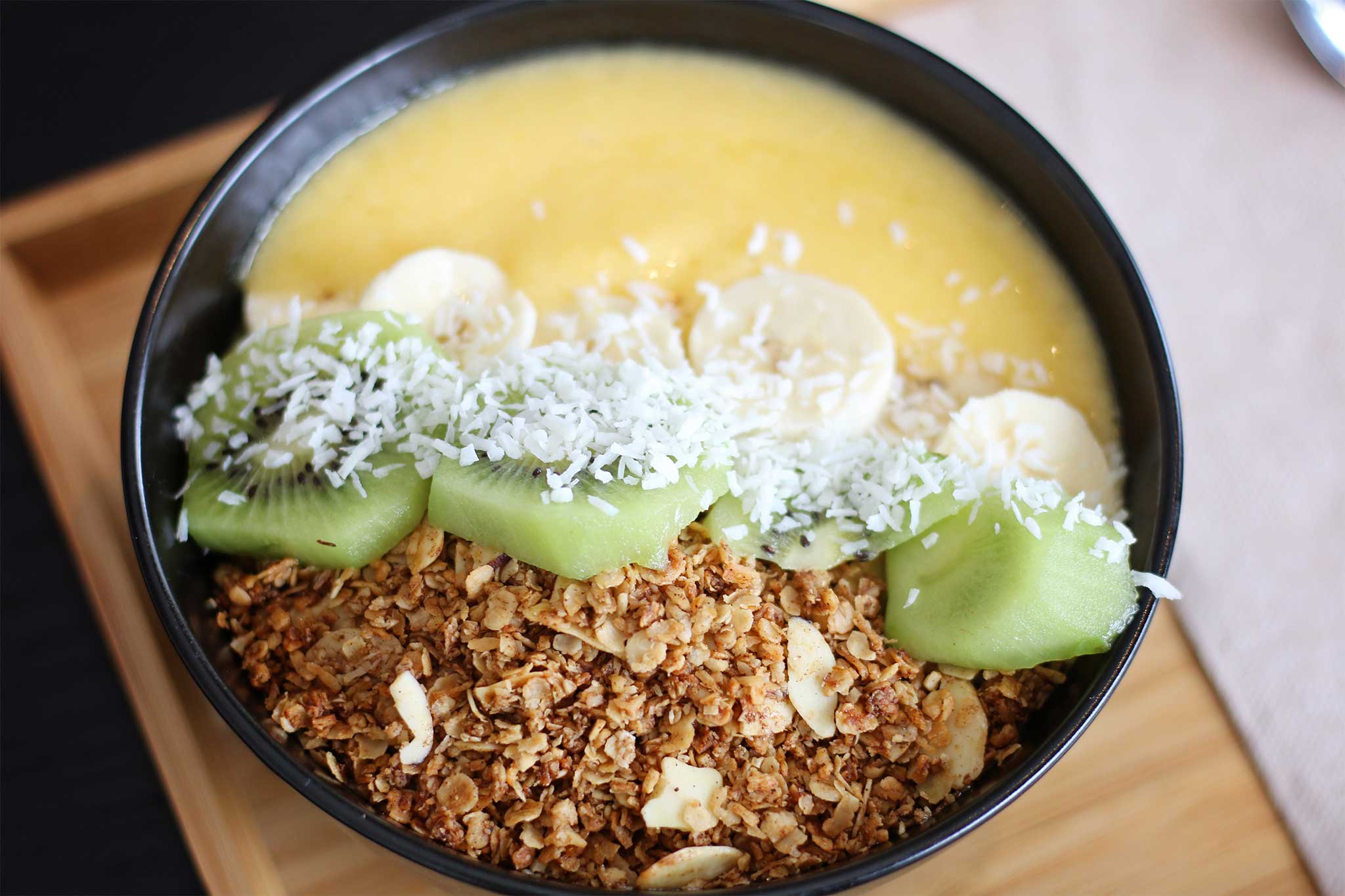 Smoothie breakfast bowl with fruit and granola on top
