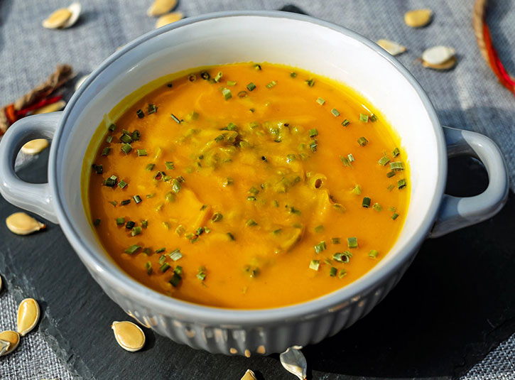 Curried squash soup with herbs and seeds