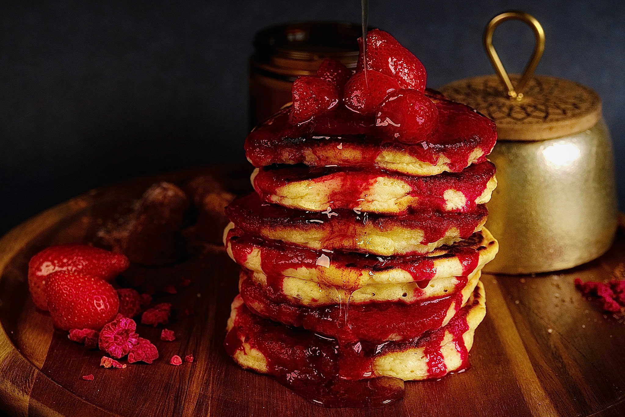 Canada Day coloured-pancakes with strawberry sauce all of over them