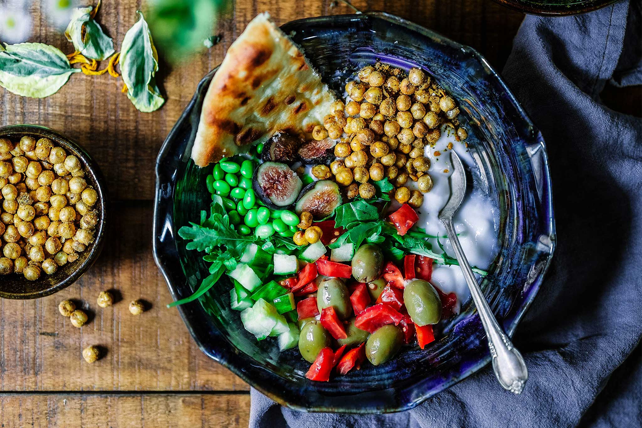 Fresh and healthy bowl with vegetarian proteins and a side of pita