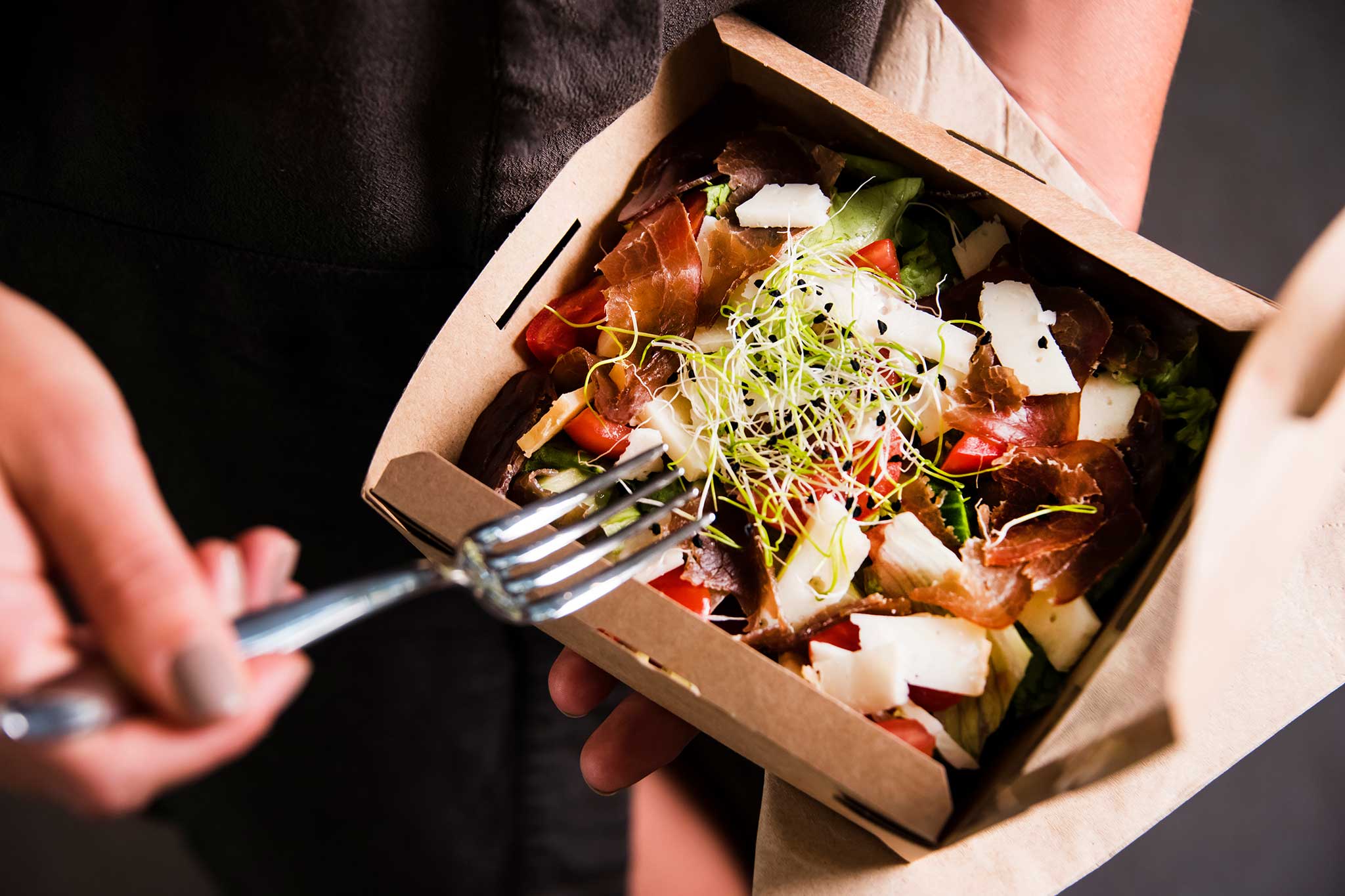 Eating from a compostable takeout lunch container