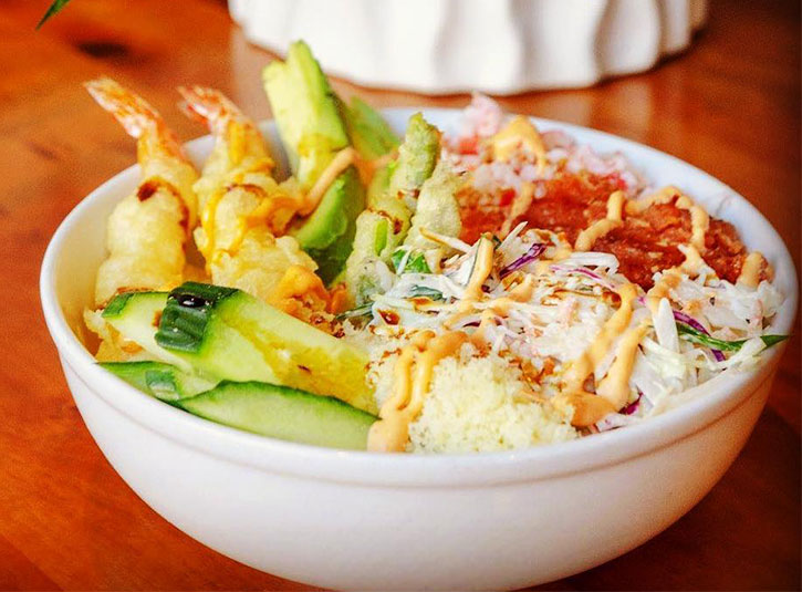 Sushi bowl with rice, veggies, fried shrimp, and sauce