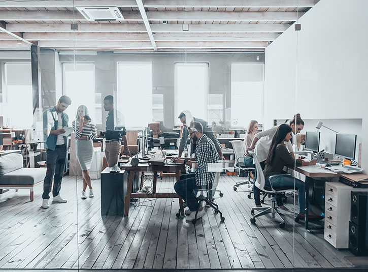 An office full of workers at their computers