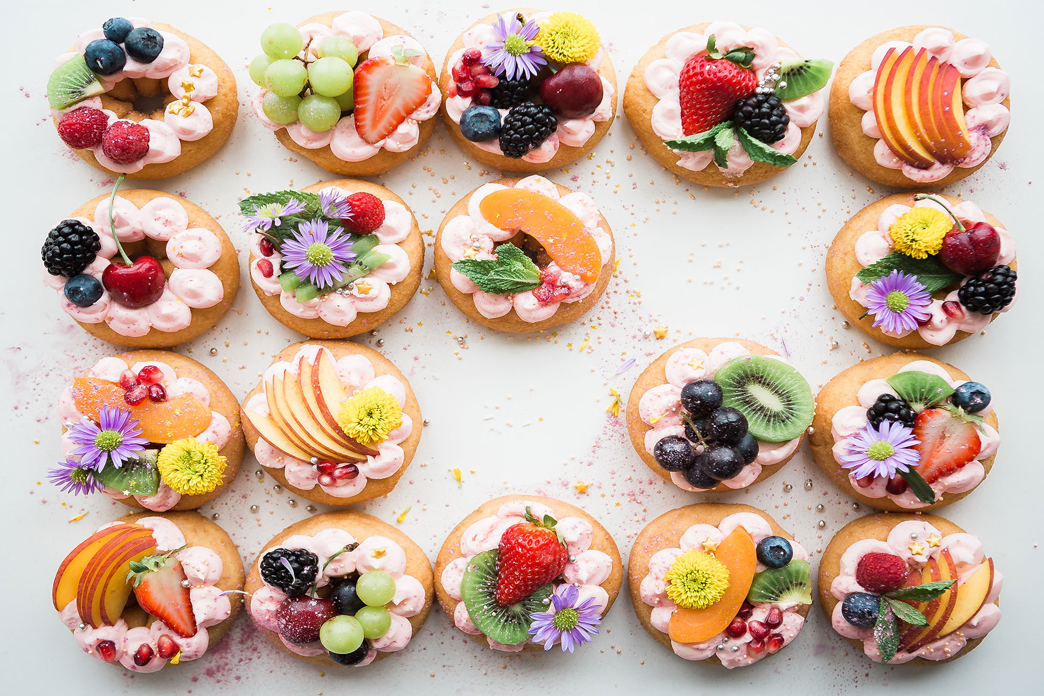 Fruit-covered desserts on a marble countertop