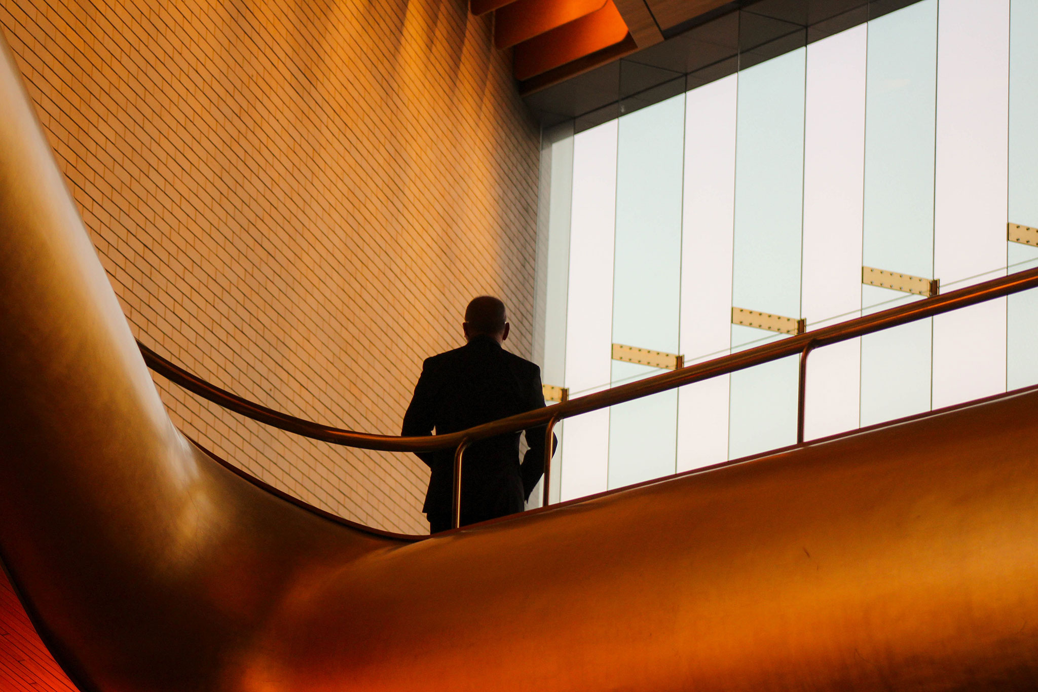 A CEO stands in a modern designed foyer