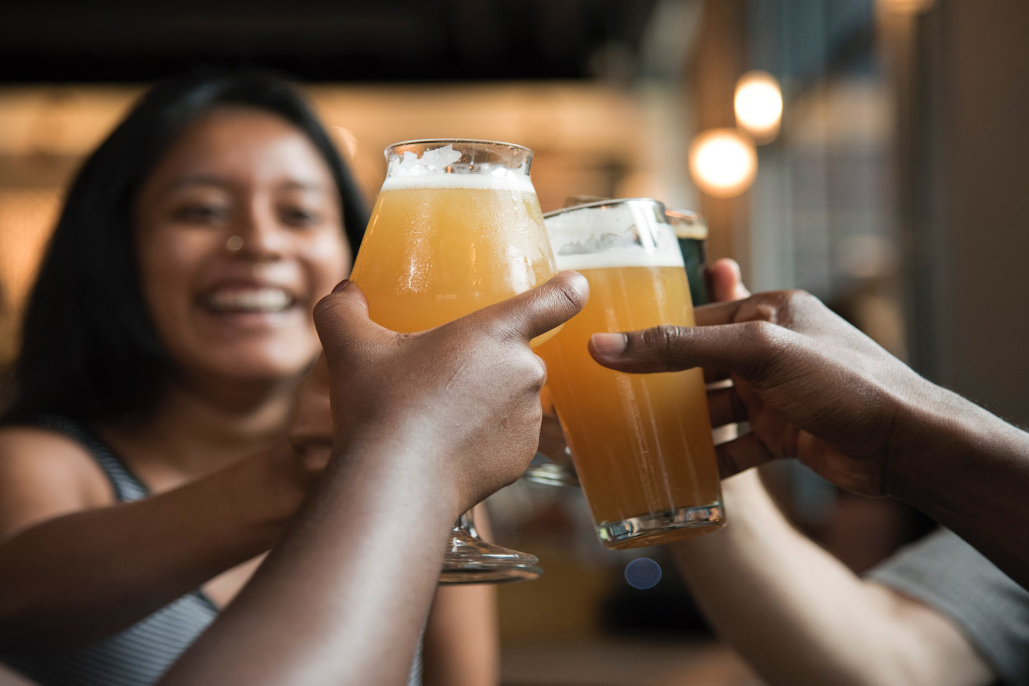 A happy hour beer toast among employees