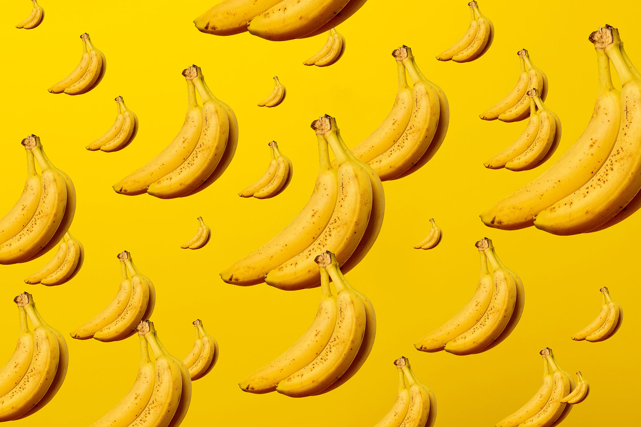 Yellow bananas on a yellow background