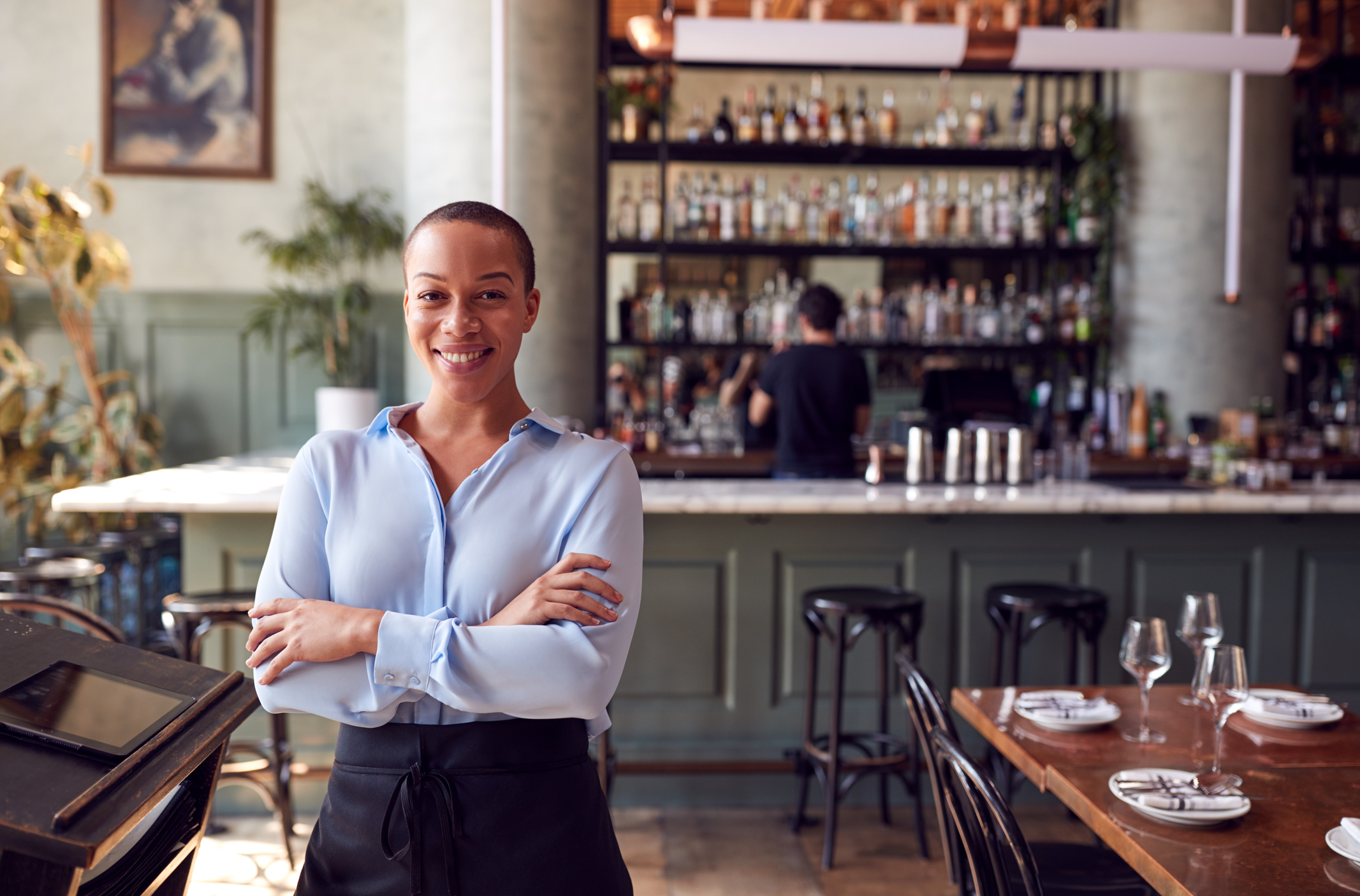 A professional woman smiling in a restaurant