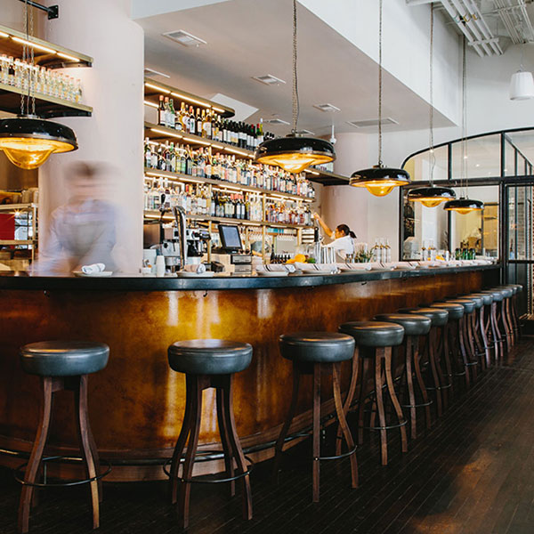 An open bar with tucked bar stools.