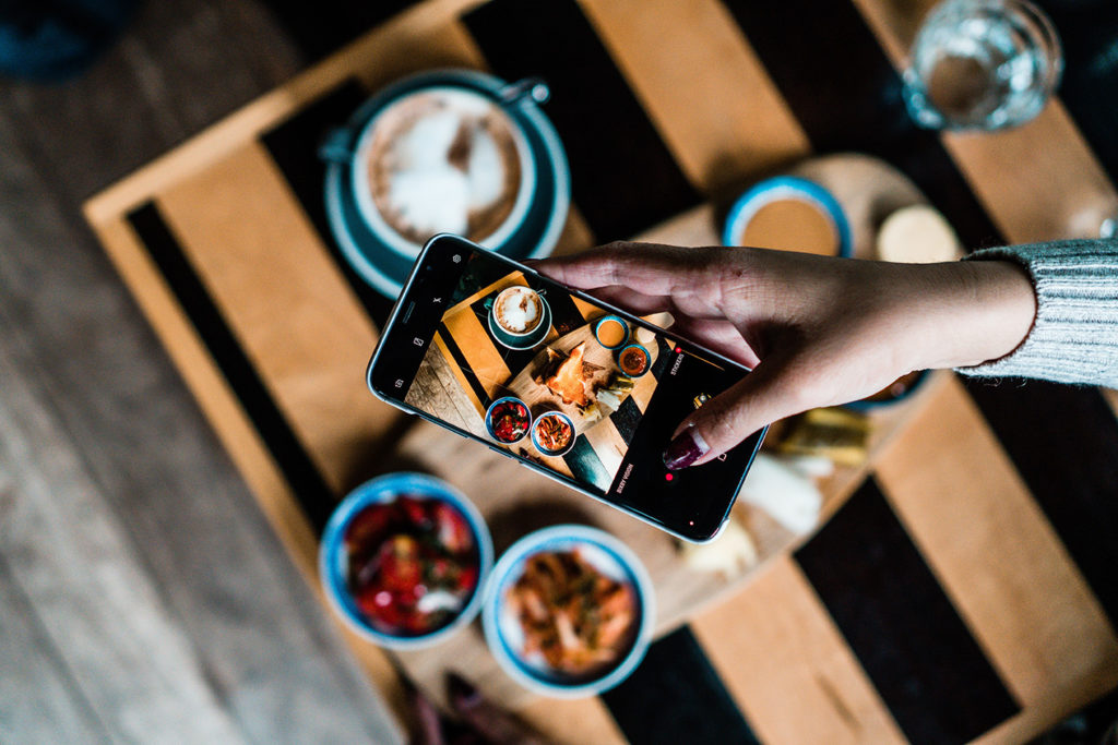 A phone taking a photo of food