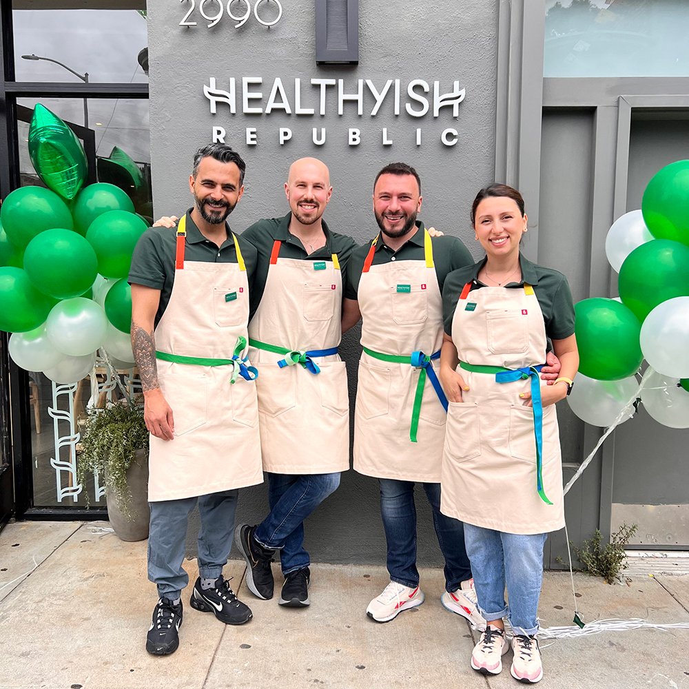 The Healthyish Republic team standing in front of their restaurant opening.