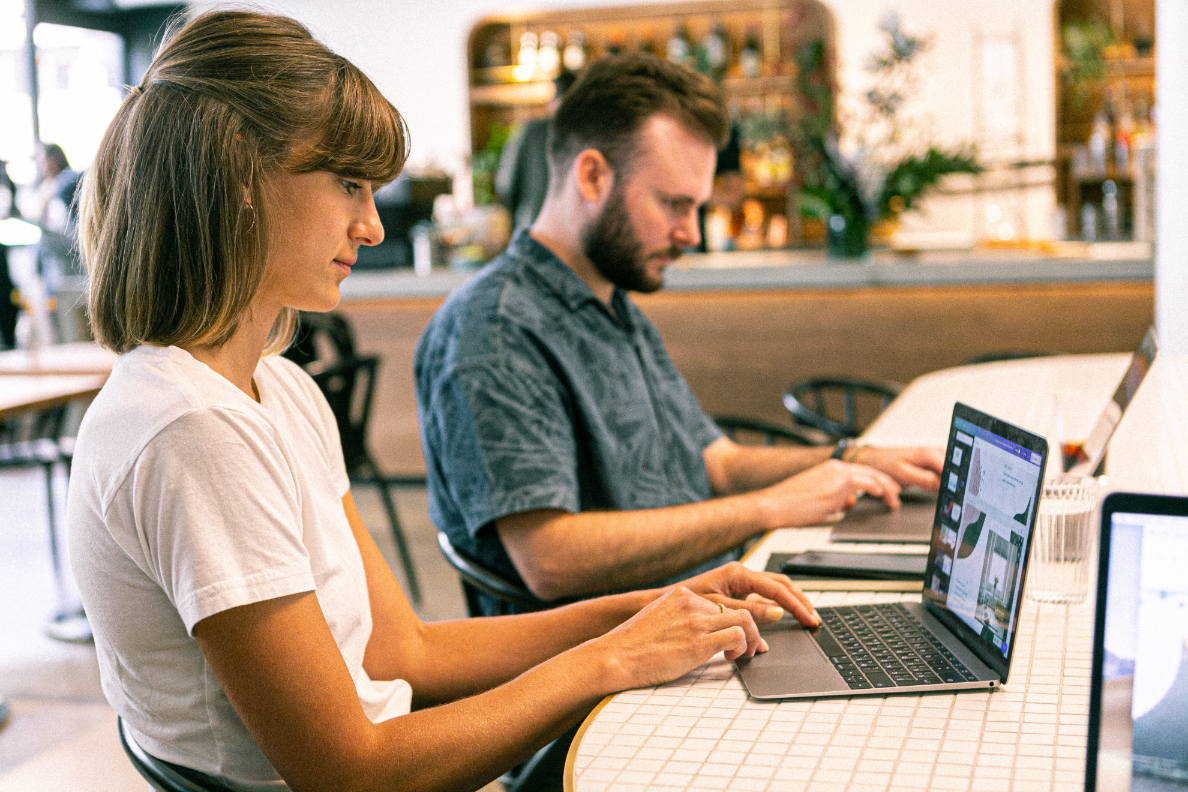 Two people working on their laptops