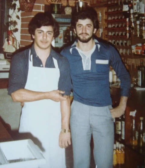 The owner of Best Falafel, Hisham Watter, and his brother standing together in their first restaurant job in England, 1978.