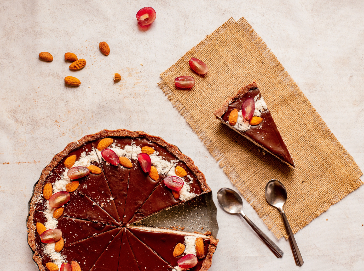 A cut cake shown with one slice on a napkin