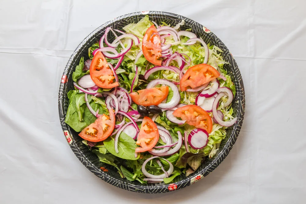 A large circular platter of the Organic House Salad.