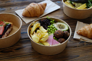 Compostable to-go containers and napkins holding meals