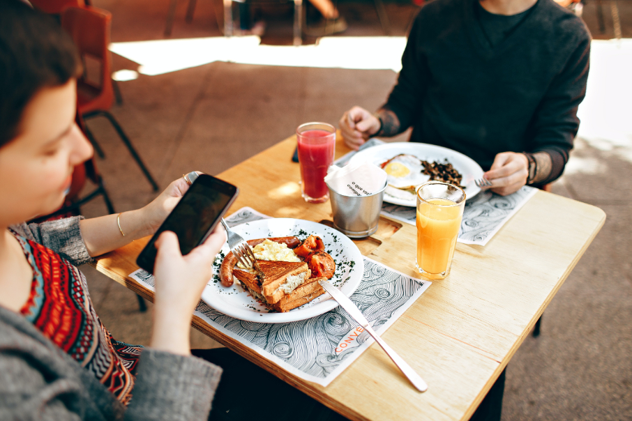 Someone taking a photo of their meal at a restaurant