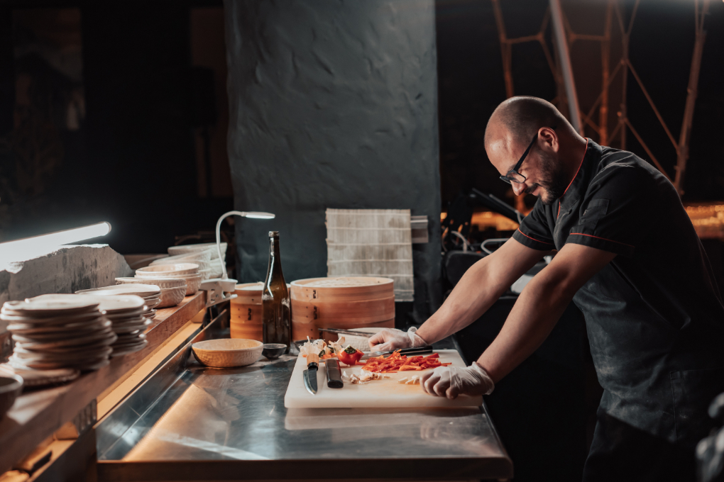 A professional chef in a modern kitchen, preparing for service