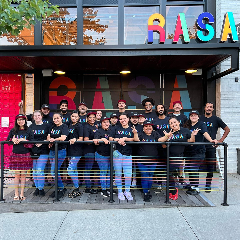 The entire RASA team standing in front of their restaurant.