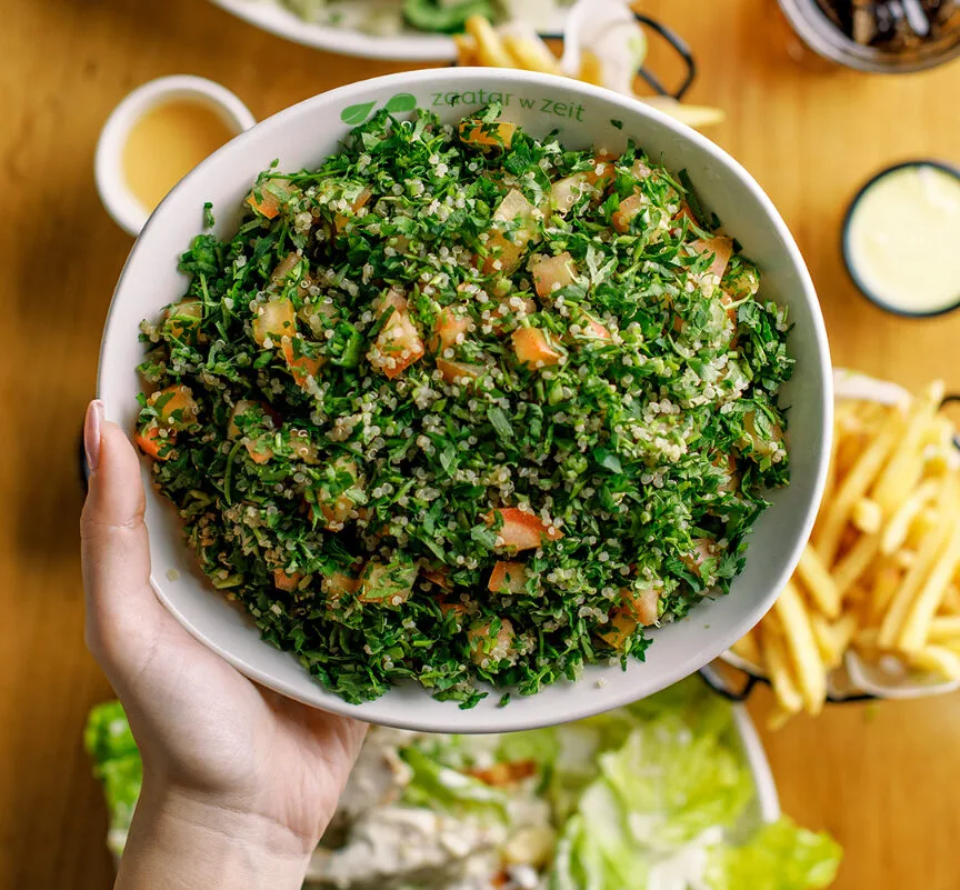 A vibrant green bowl of salad.