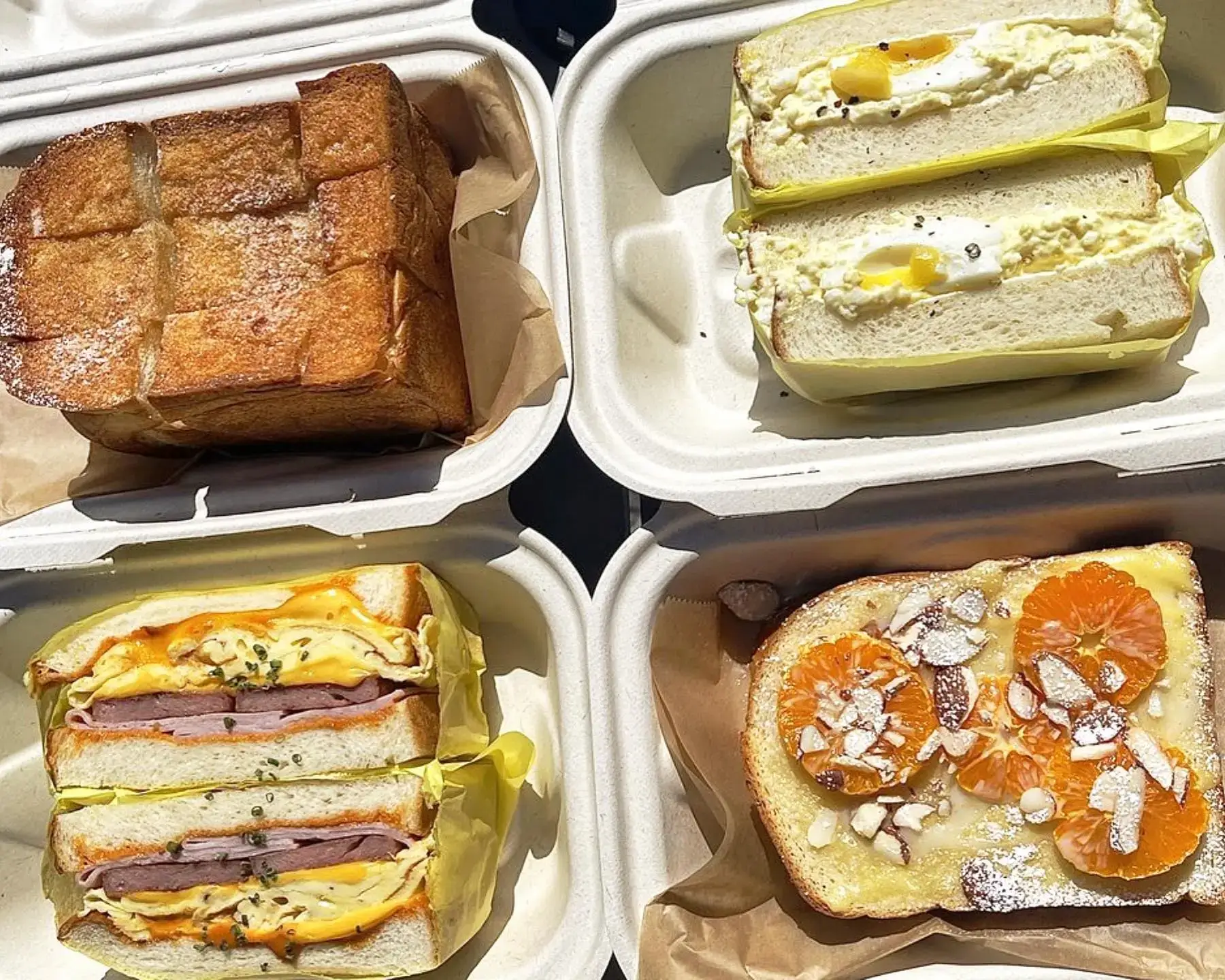 Four different Milk Bread bakery offerings in to-go containers