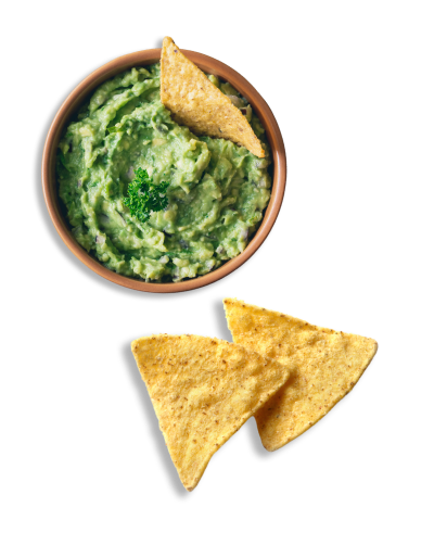 A bowl of guacamole with tortilla chips.