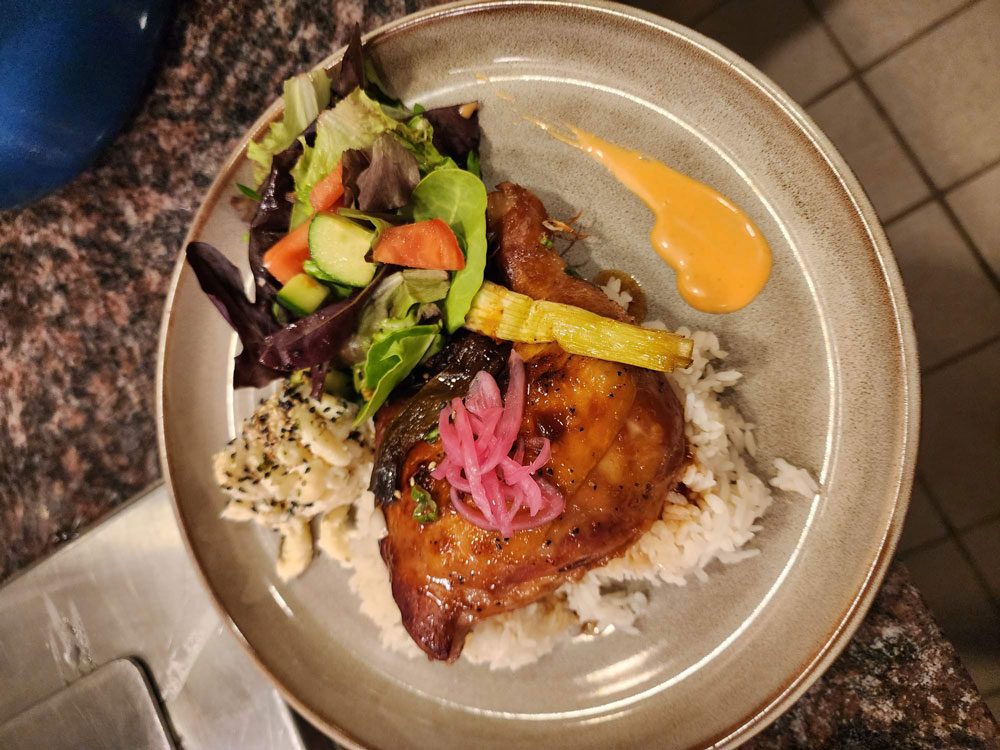 A plate of white rice, shaved cabbage and arugula salad.