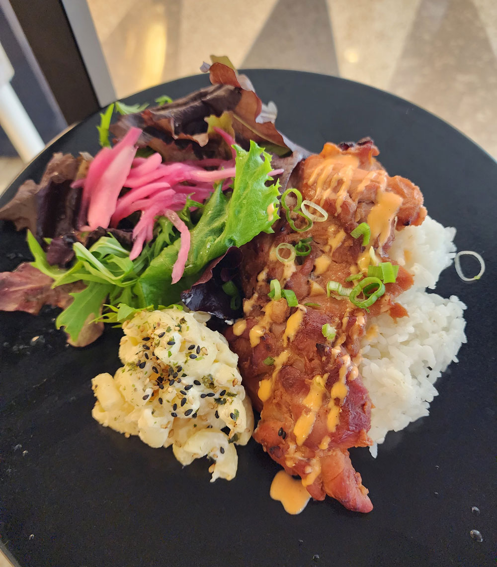 A plate of white rice, shaved cabbage and arugula salad.