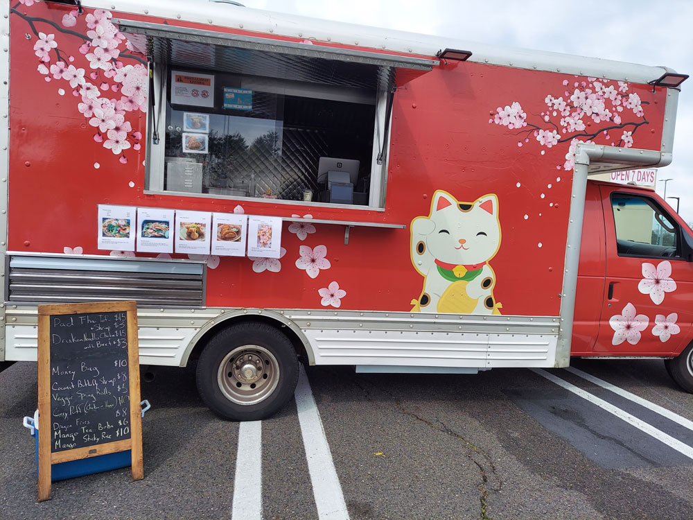 A red food truck open for service.